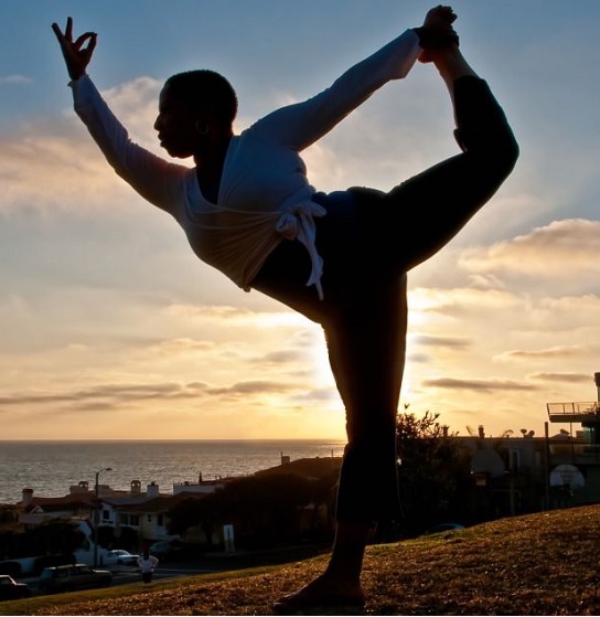 Black woman practicing dancer yoga pose